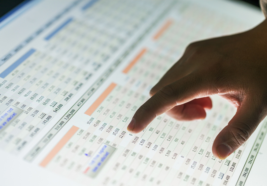 Person points at numbers on a chart